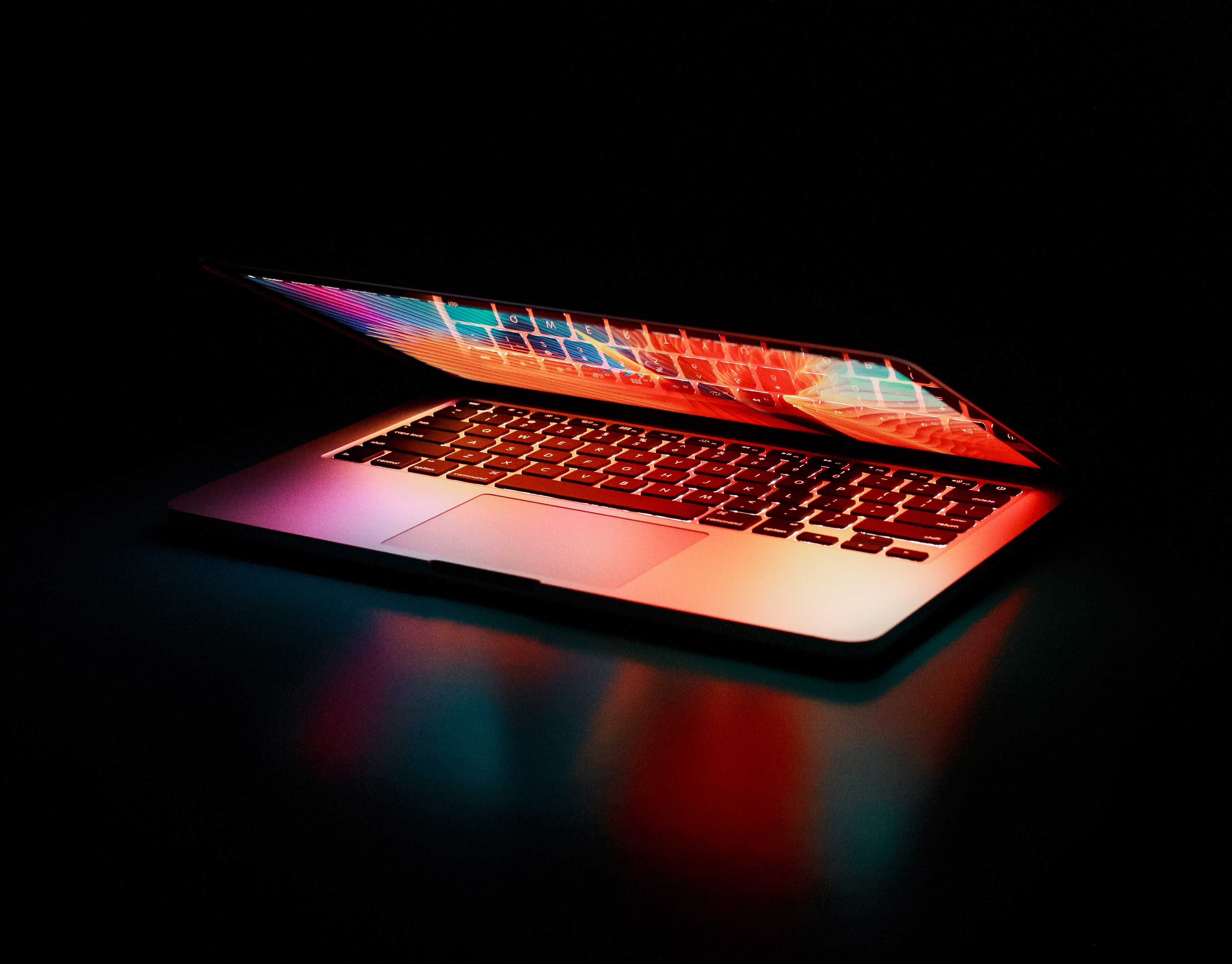 semi opened laptop computer turned on reflection